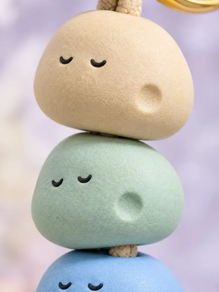Pebble Trio Charm, close-up of the surface and dent